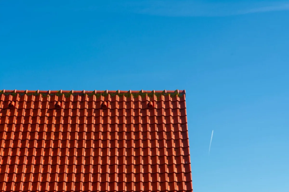Tile roof gable in full sun, the kind of exposure that sets roof life in West Jordan, UT
